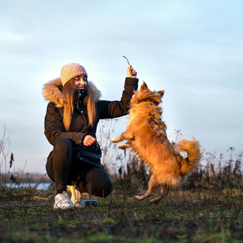 woman training intelligent dog