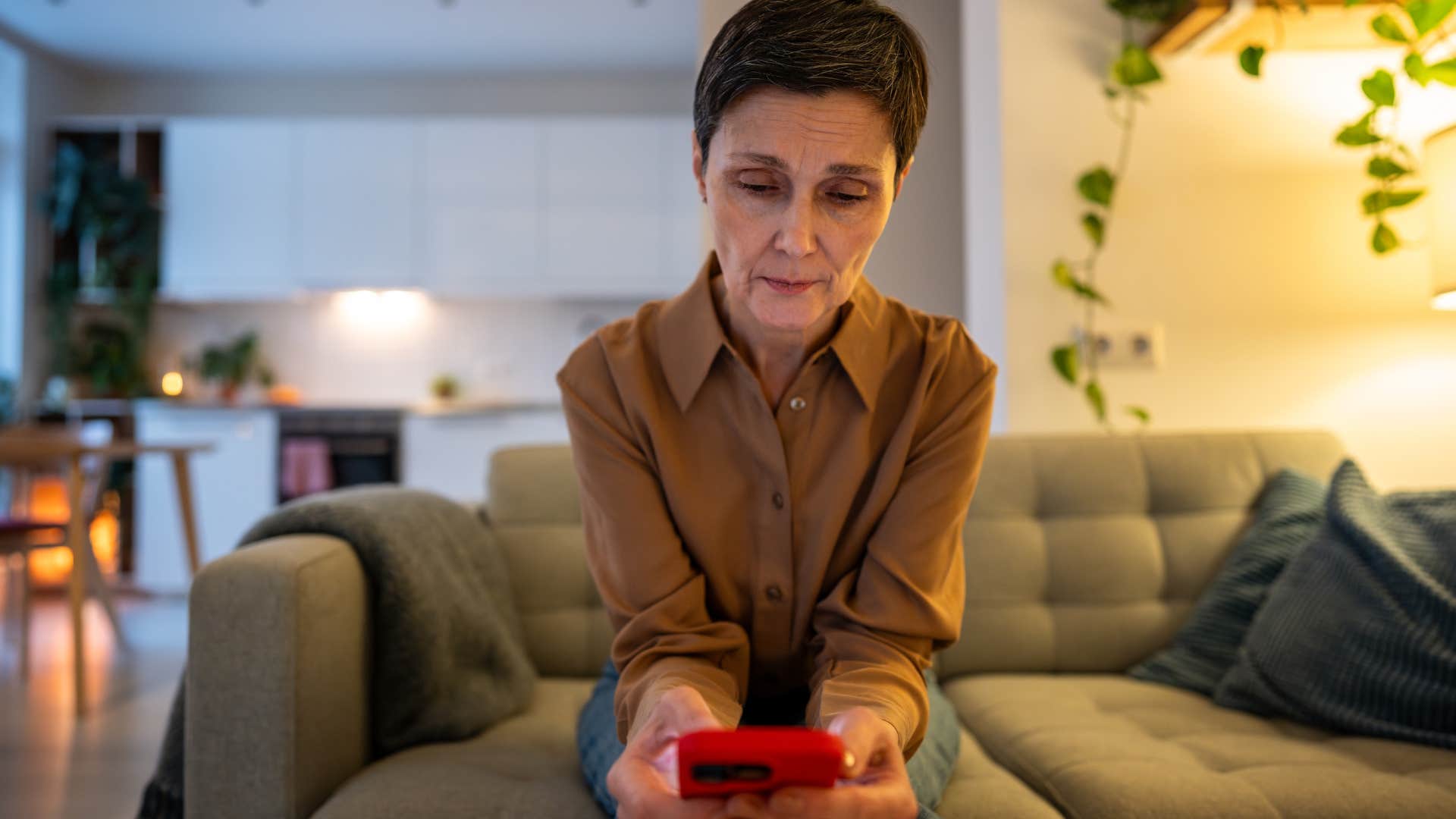 woman who always reaches out first looking at her phone