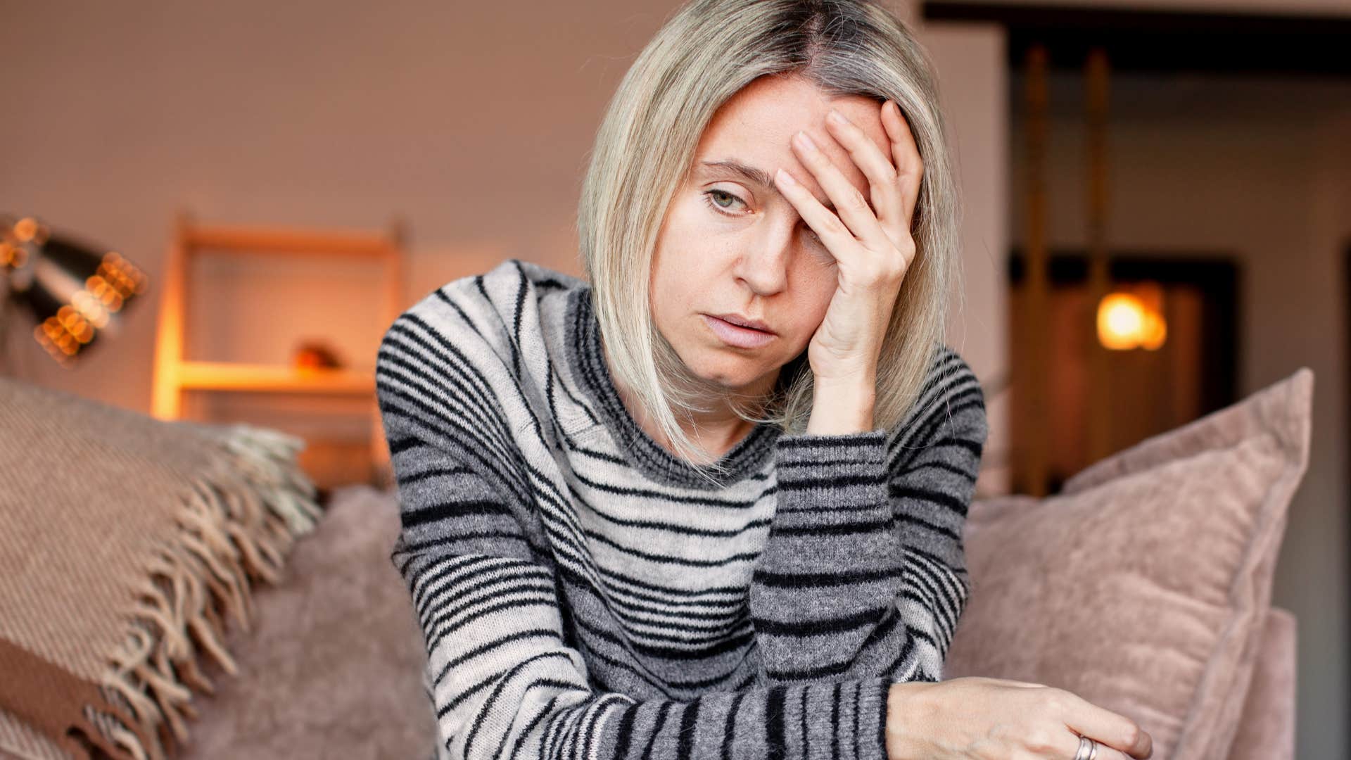 sad woman who equates loyalty to self-sacrifice sitting at home