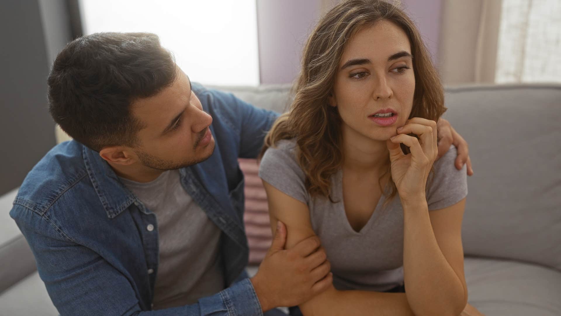 woman over-apologizing for everything sitting with partner