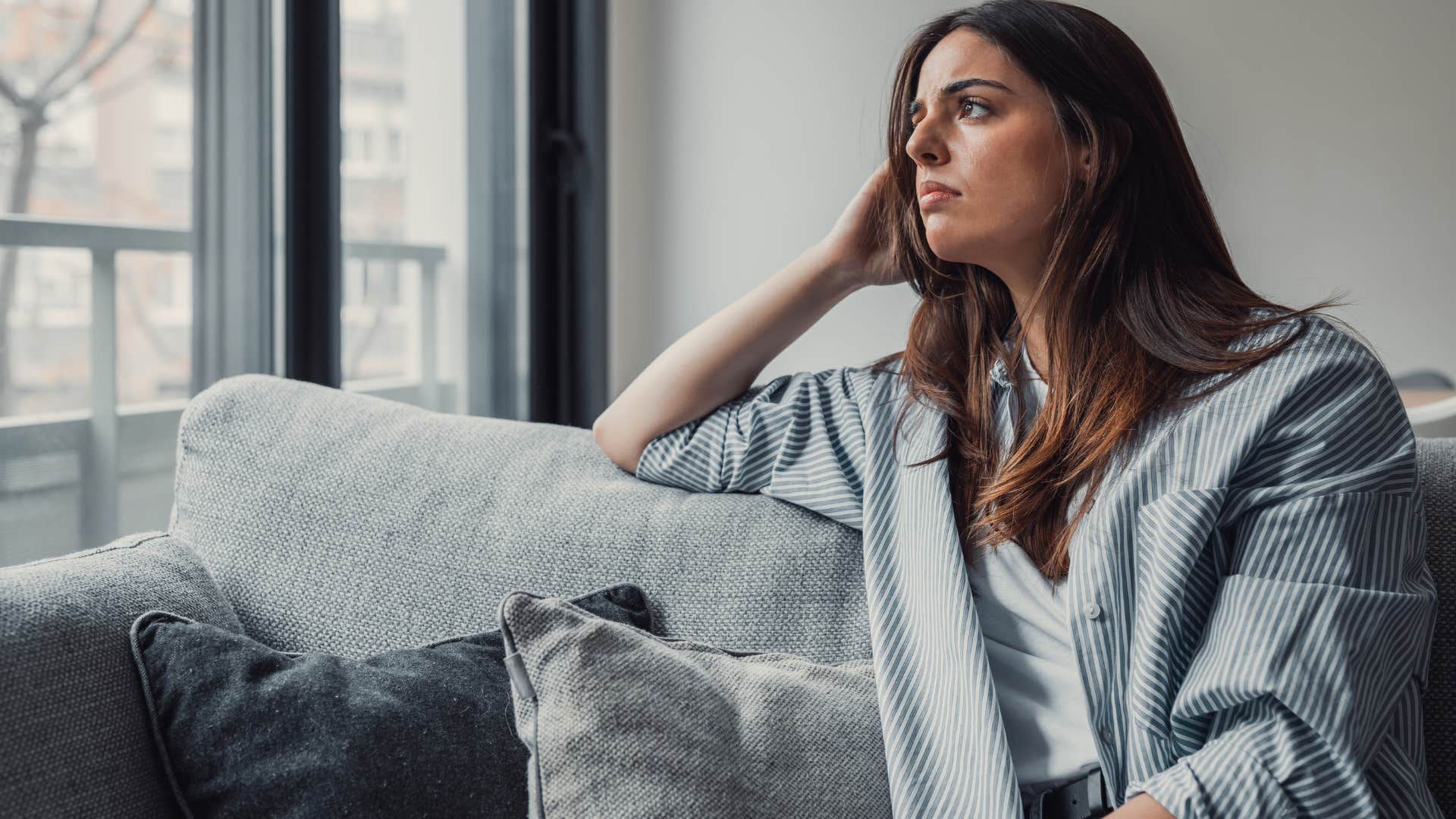 woman alone at home worrying about being too much