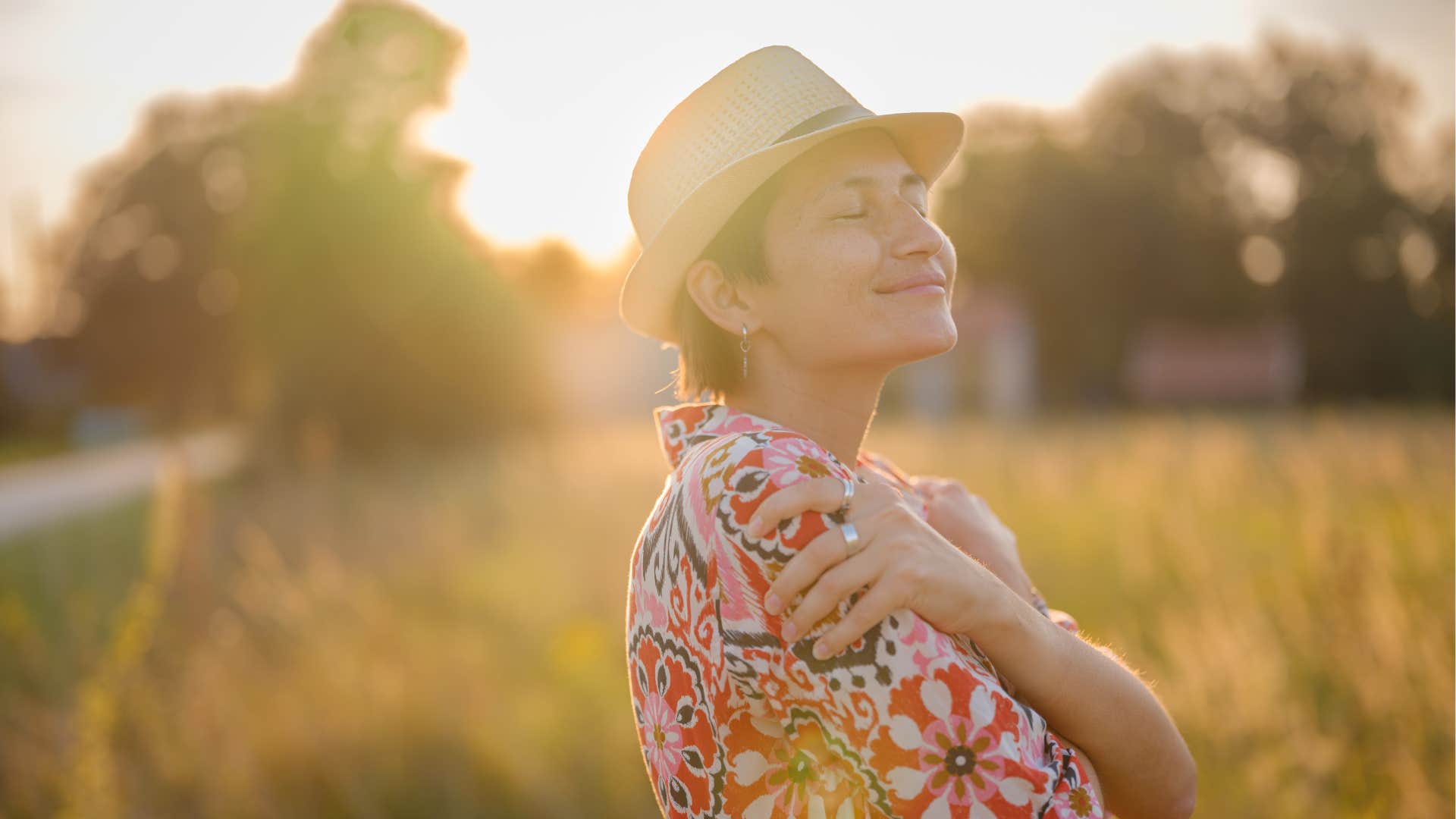 Peaceful person hugs themselves showing post-divorce happiness