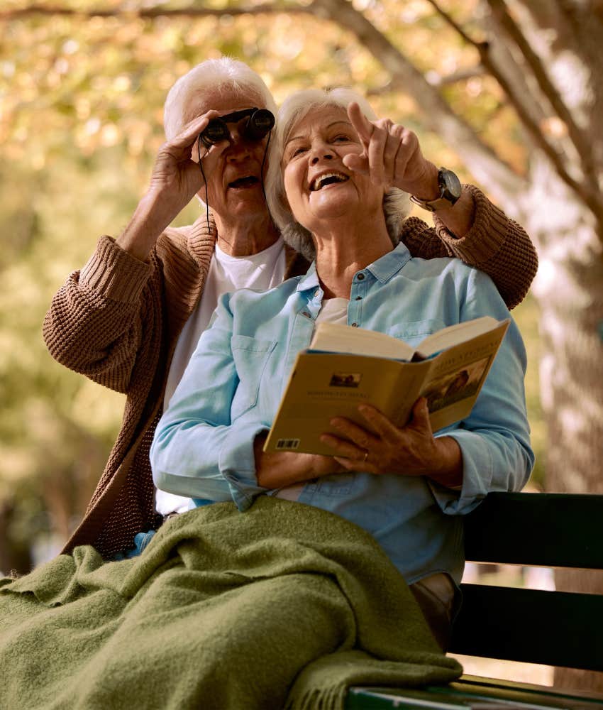 Happy elder couple bird watching showing they have same communication habits