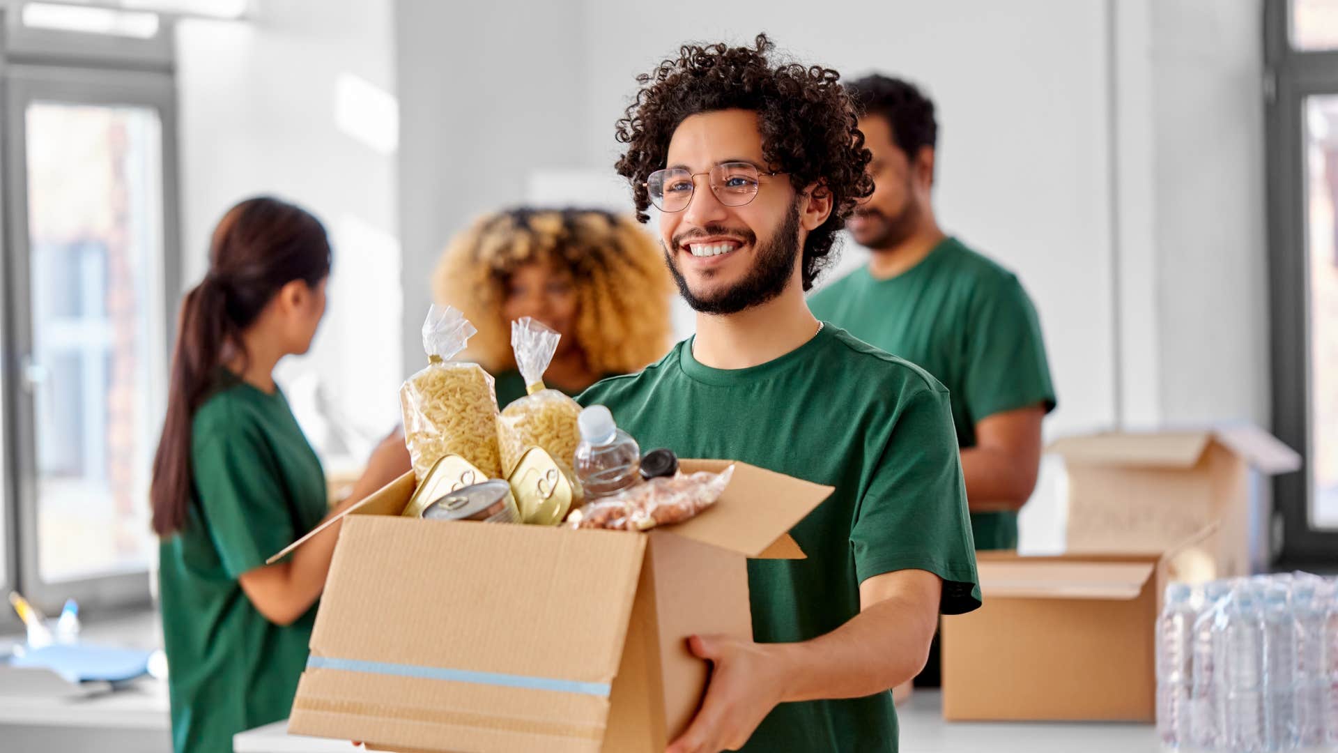 man volunteering helping carry boxes