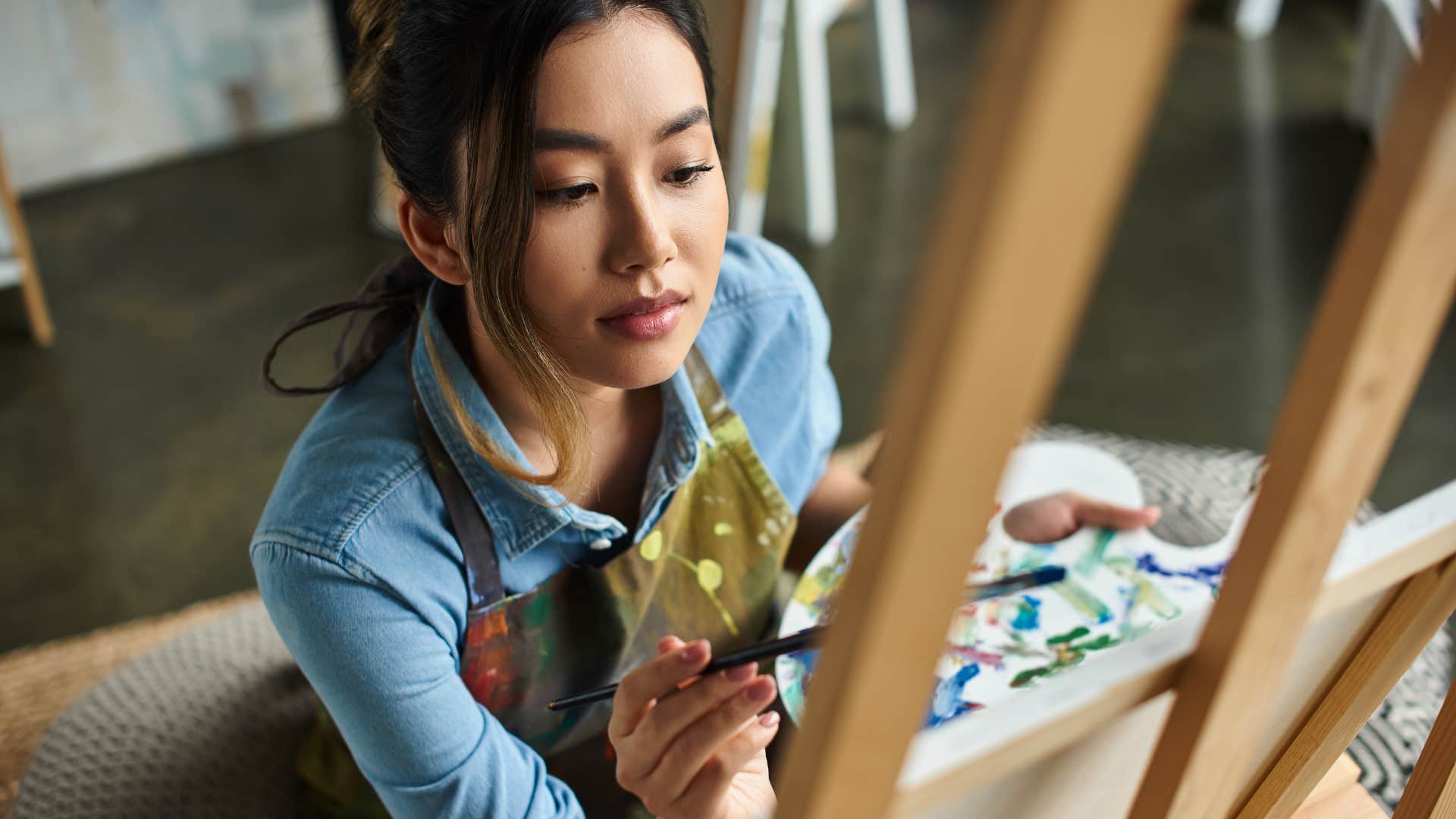 Creative person paints showing way to be happier