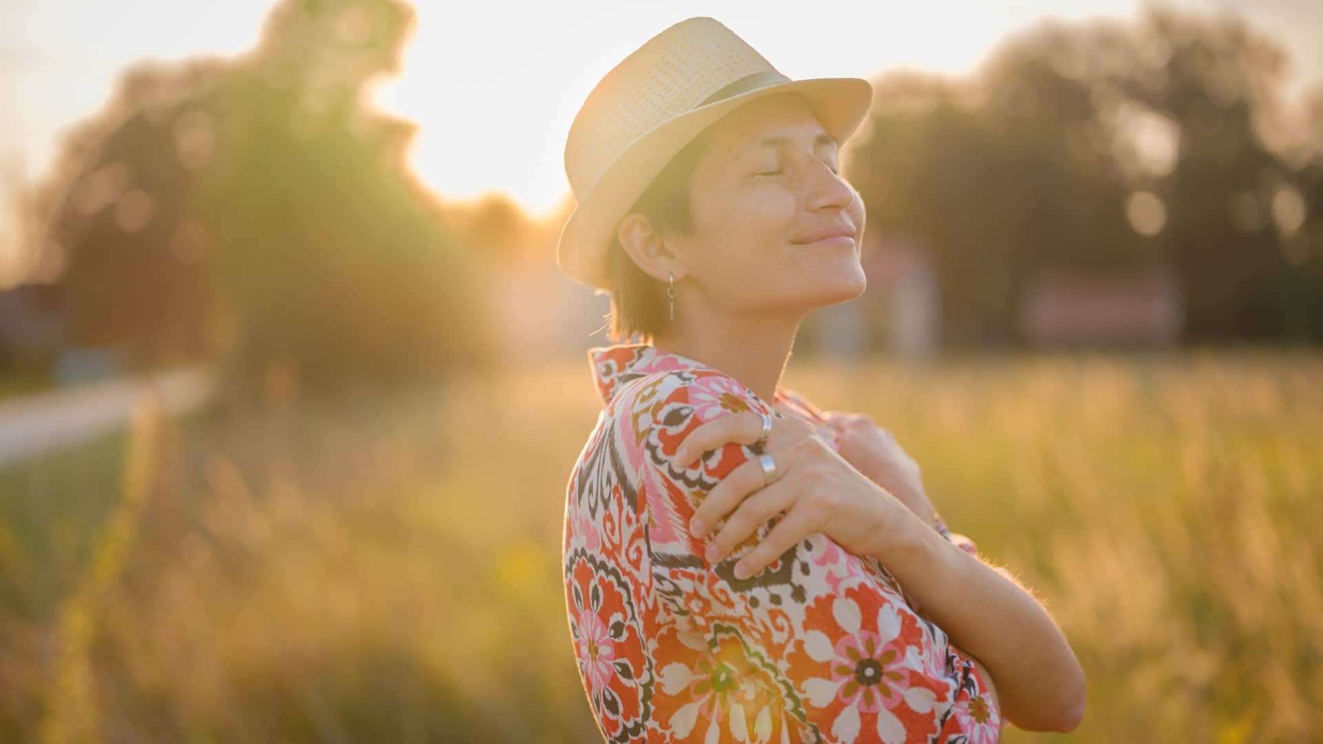 Relaxed person hugs themselves shwoing way to be happier