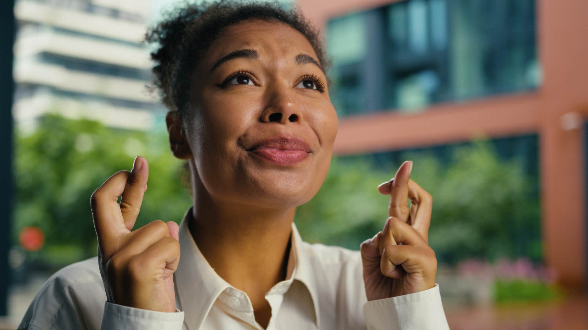 Slef assured person crosses fingers showing hope feels better