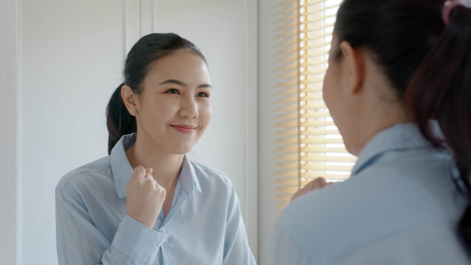 Enthusiastic person looks in mirror showing way to feel better doing what you love