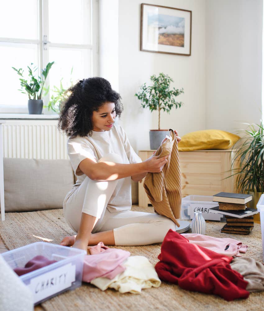 Focused person sorts clothing from closet showing winter habit 