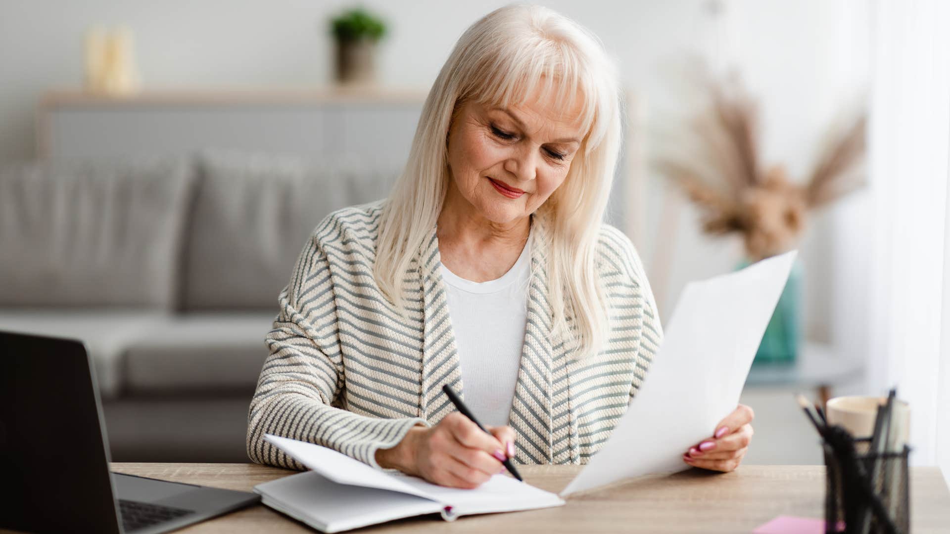 older boomer woman writing a letter