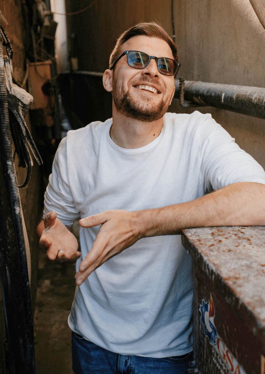 smiling man shrugging helplessly