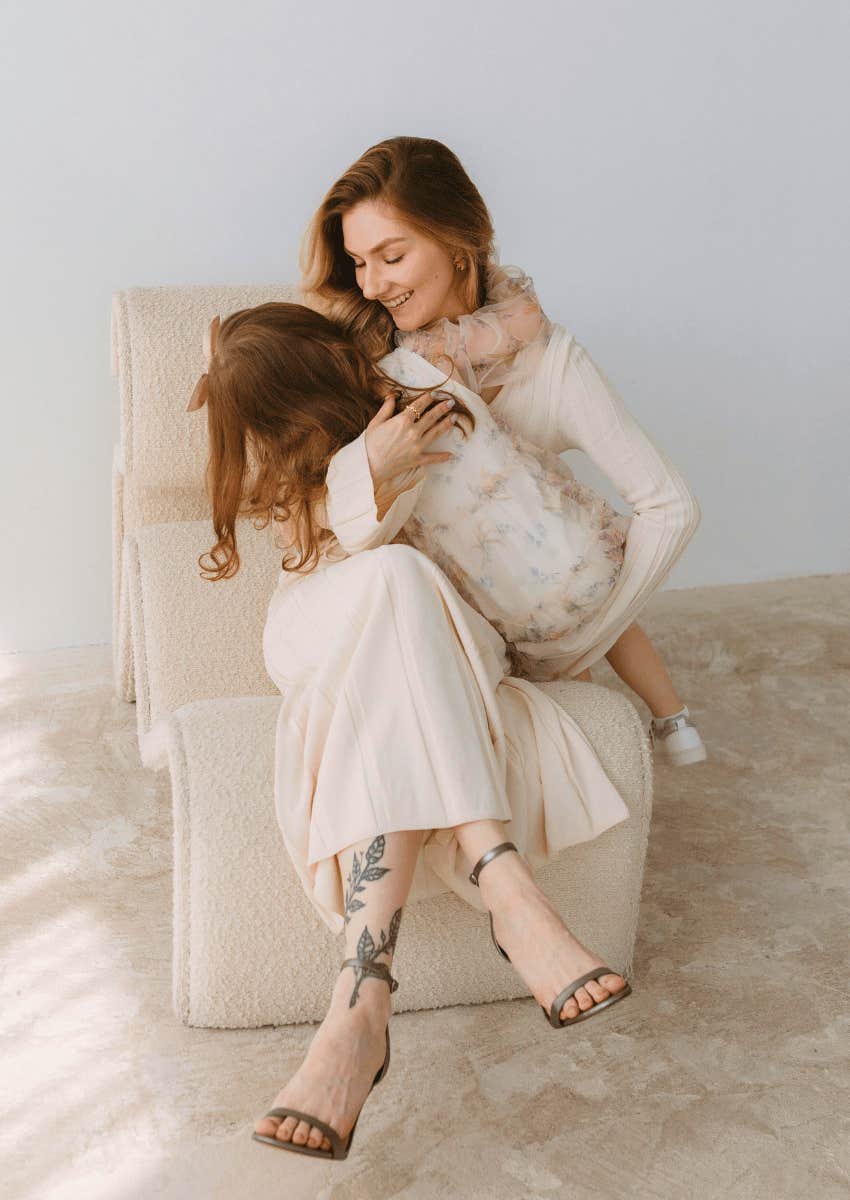 smiling mom holding her child close