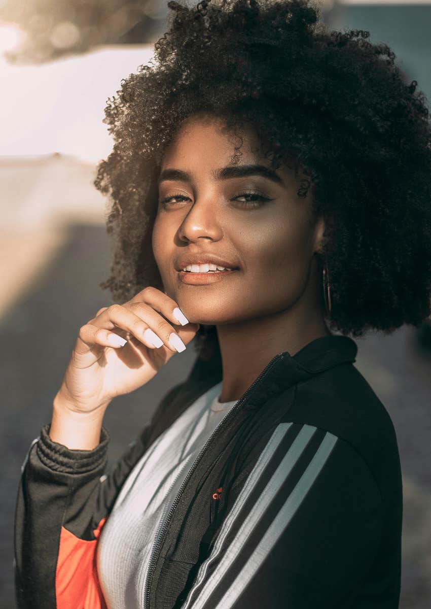 smiling young woman standing outdoors