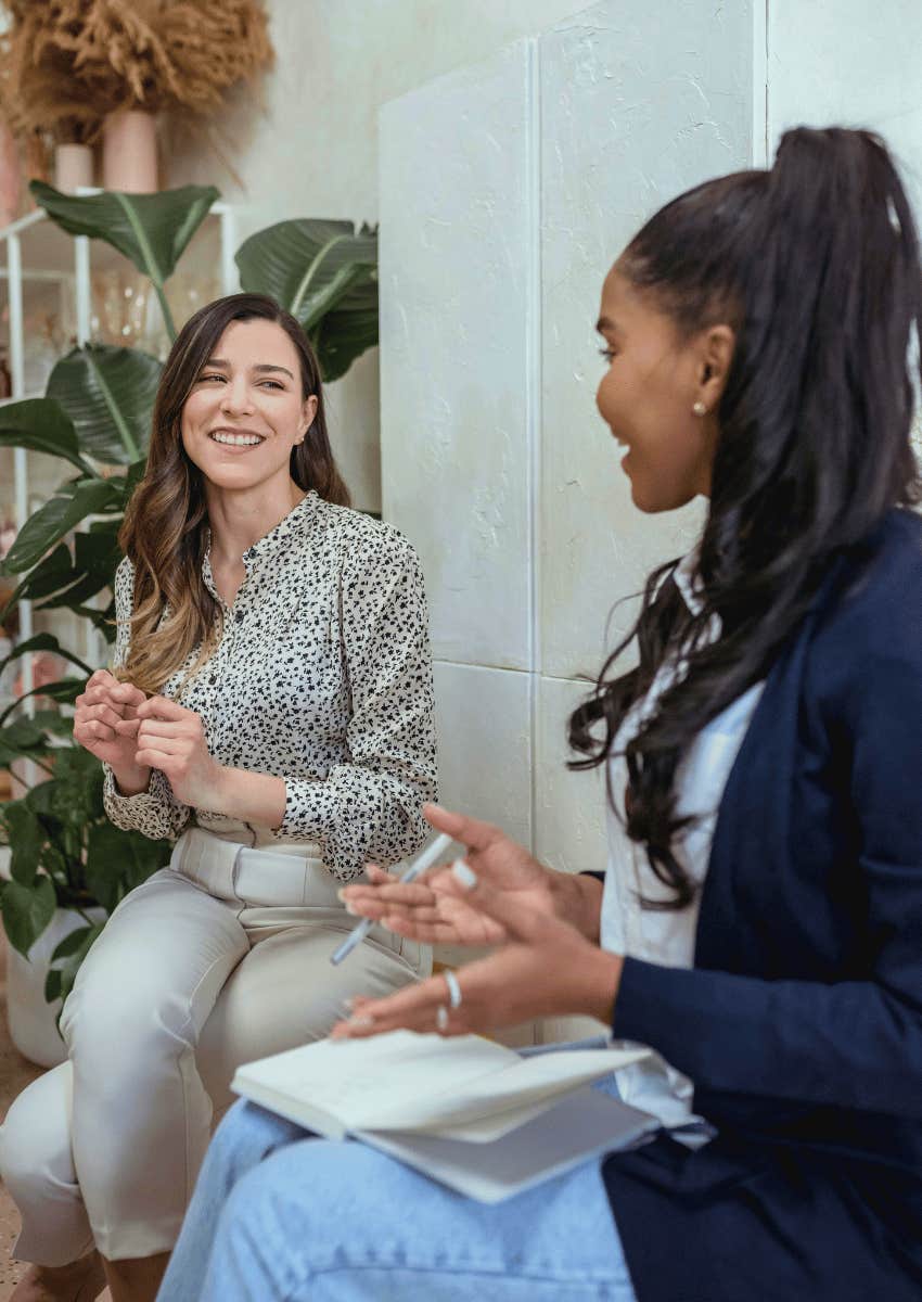 smiling young women talking with each other