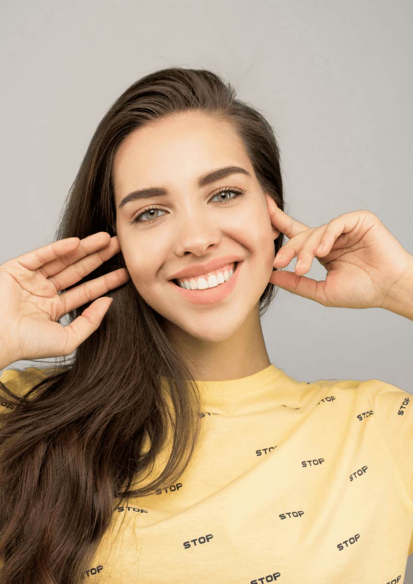 smiling young woman wearing a yellow shirt