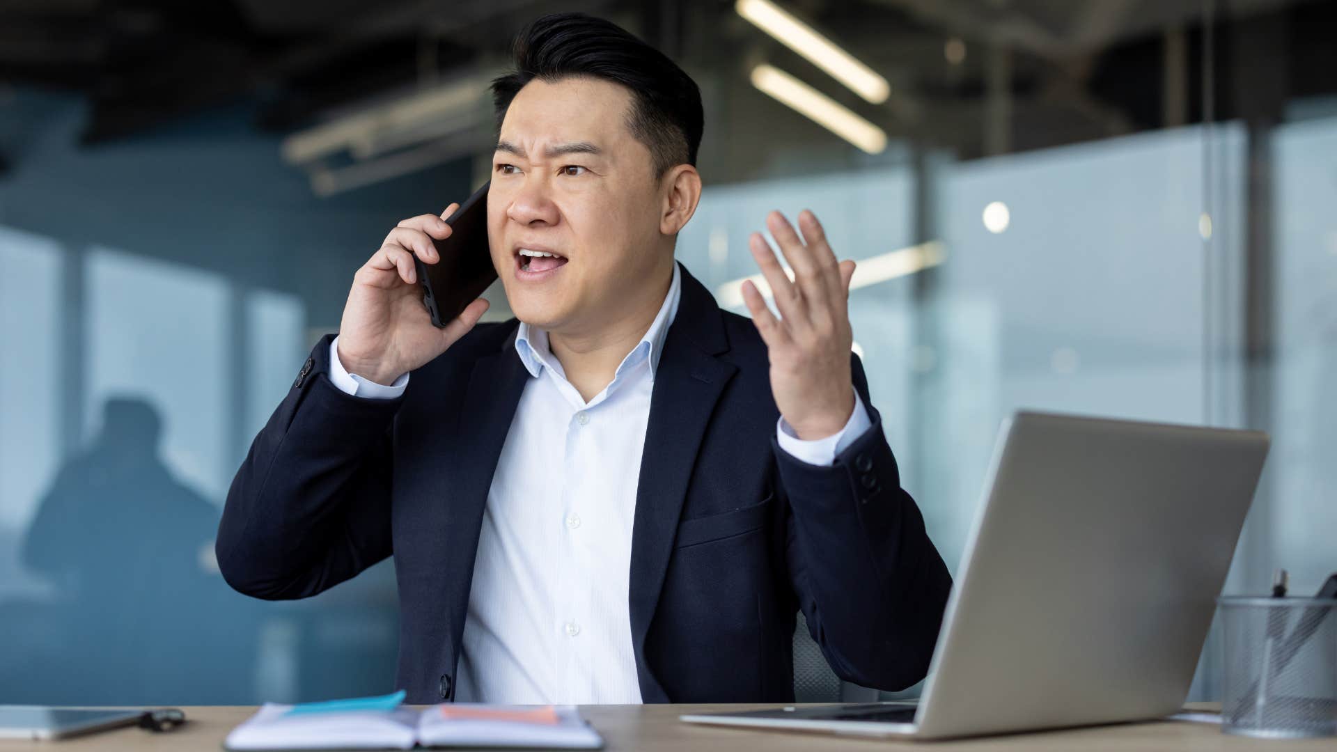 aggressive man arguing on his phone at work