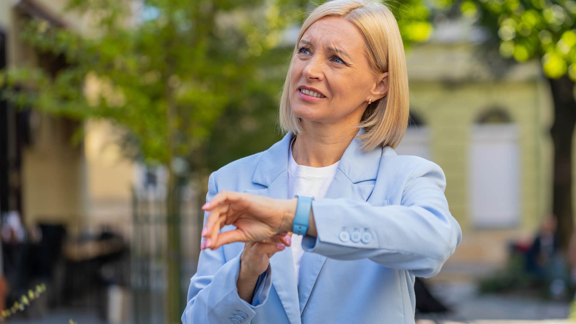 impatient woman walking around and looking at her watch