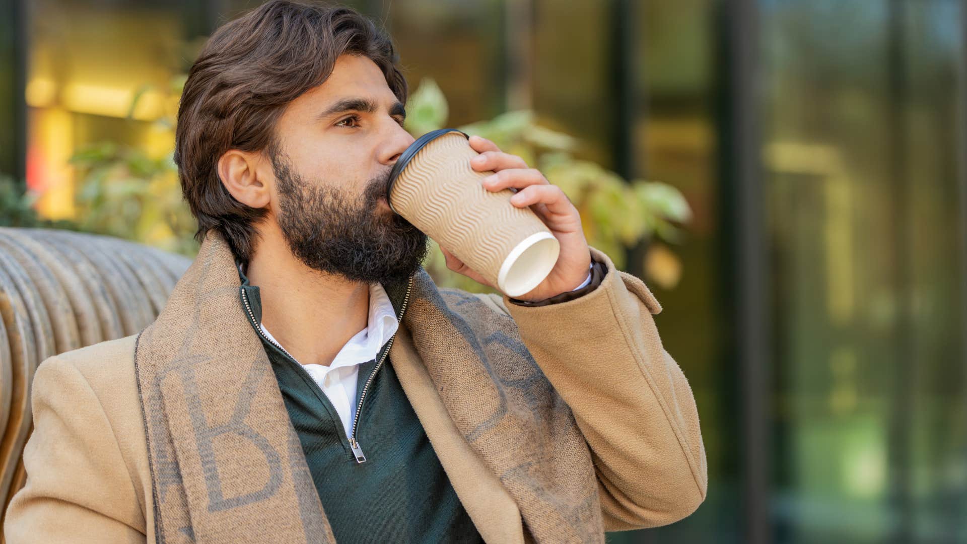 socially aware man drinking coffee outside