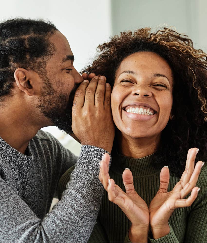 Suprised woman listens to man's secret showing songs with adult meaning