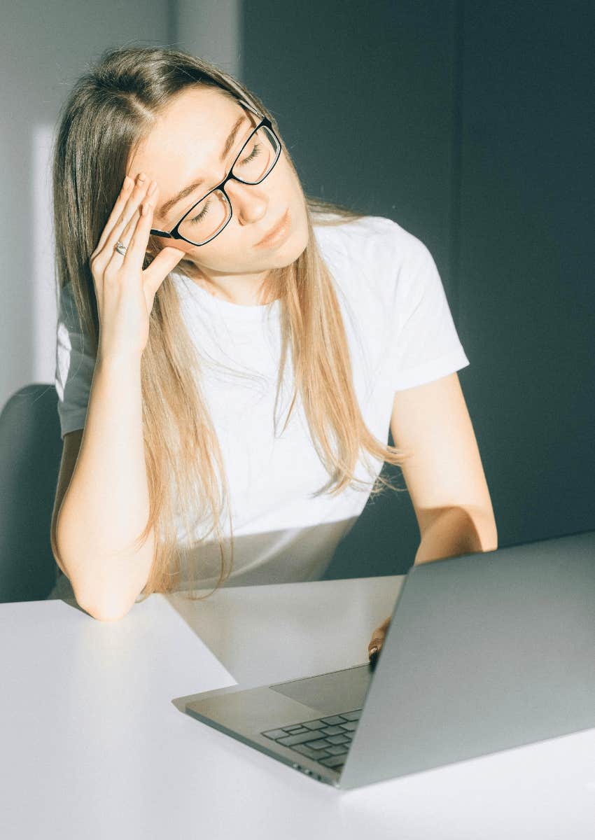 stressed woman with her hand on her temple