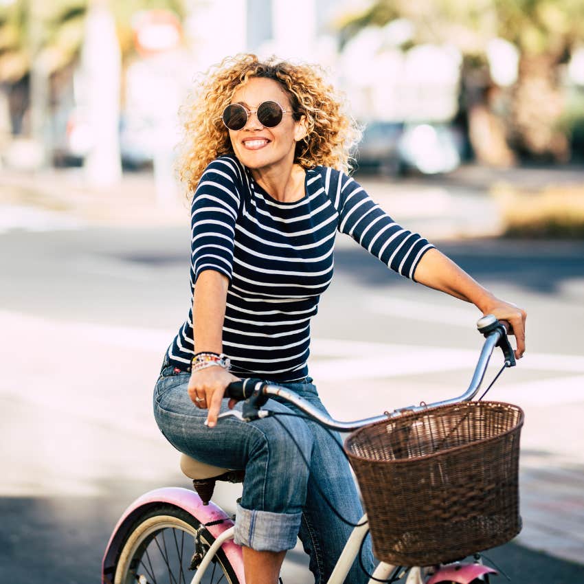 happy single woman whose relationship status isn't as socially acceptable as being in a relationship