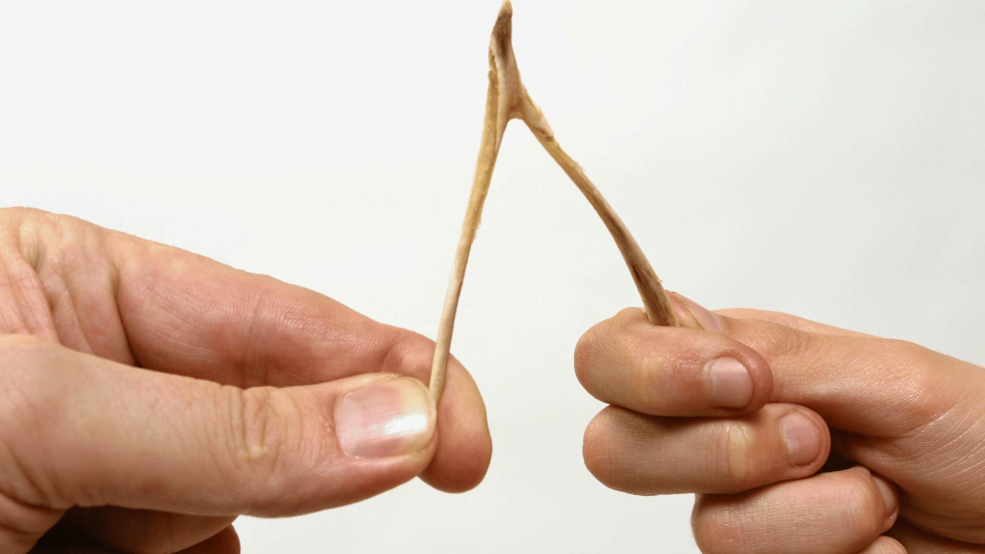 superstitious people breaking a wishbone