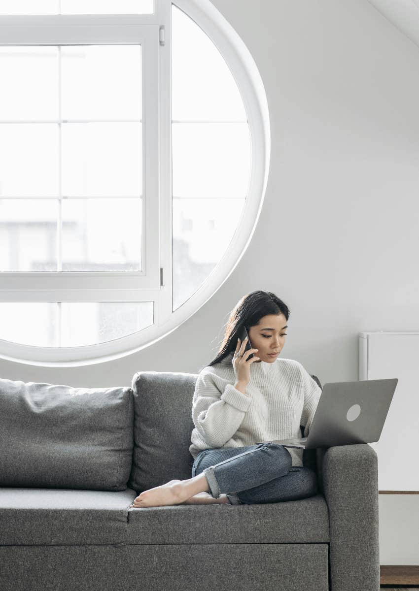 woman experiencing digital burnout because she's on her phone and laptop at the same time