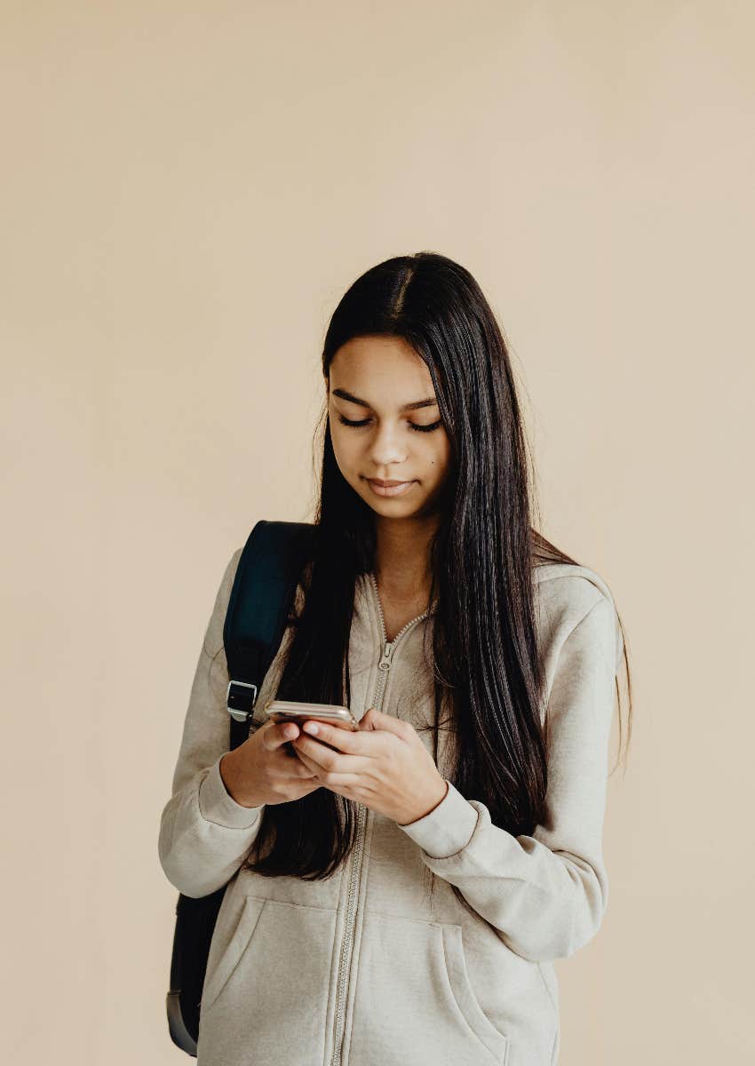 gen z woman using social media on her phone