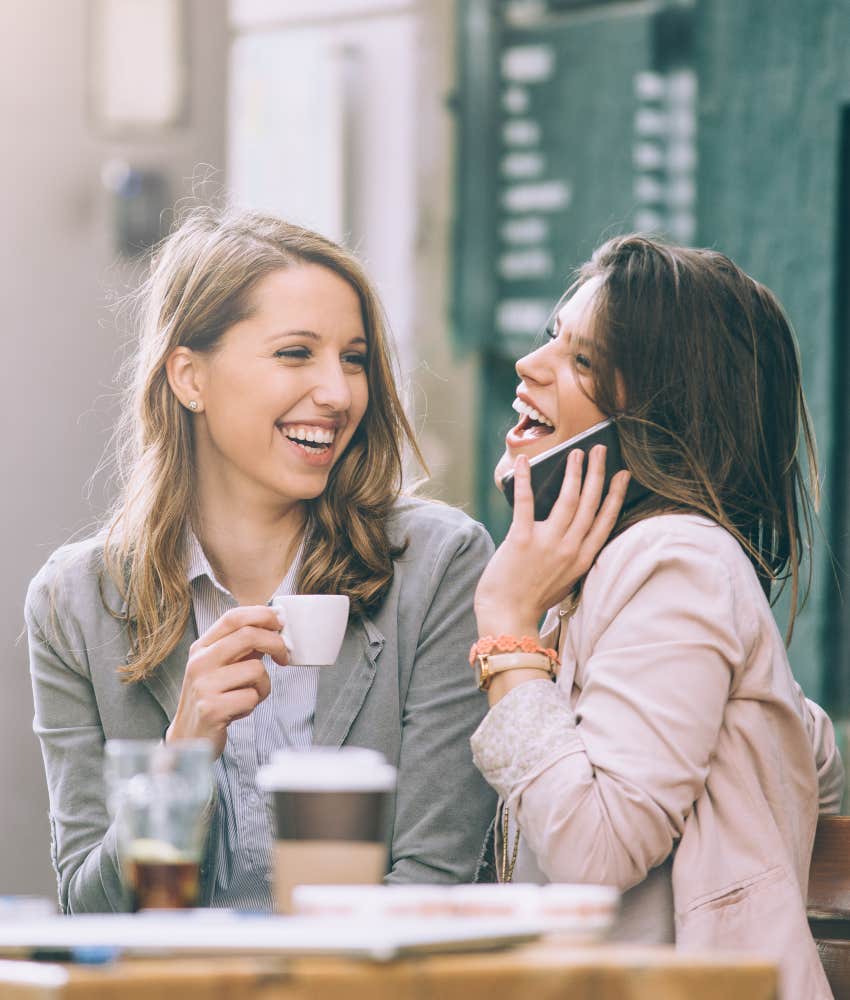 woman talking and laughing at cafe