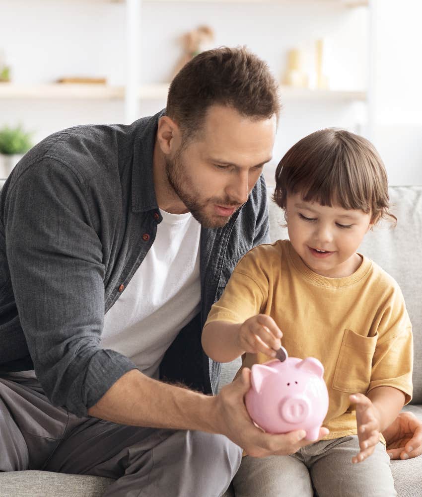 dad teaching son about saving money with piggy bank