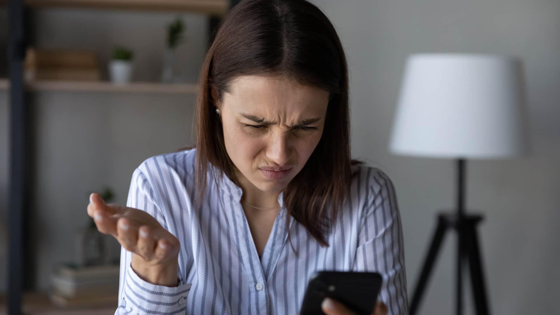 confused woman who just got a text saying if you really cared you would do this