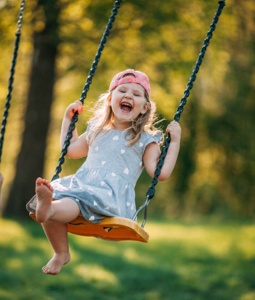 little girl happy on swing