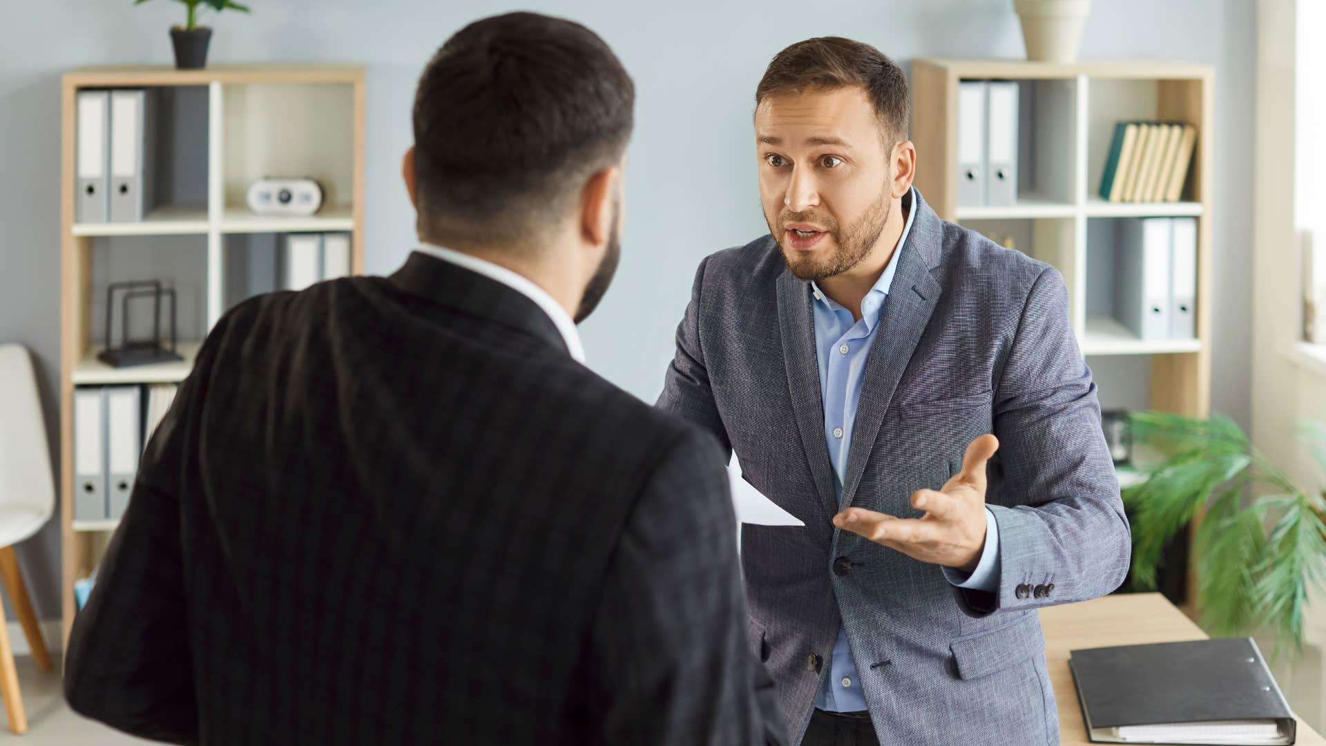 two men in suits arguing as one man says you always take things personally