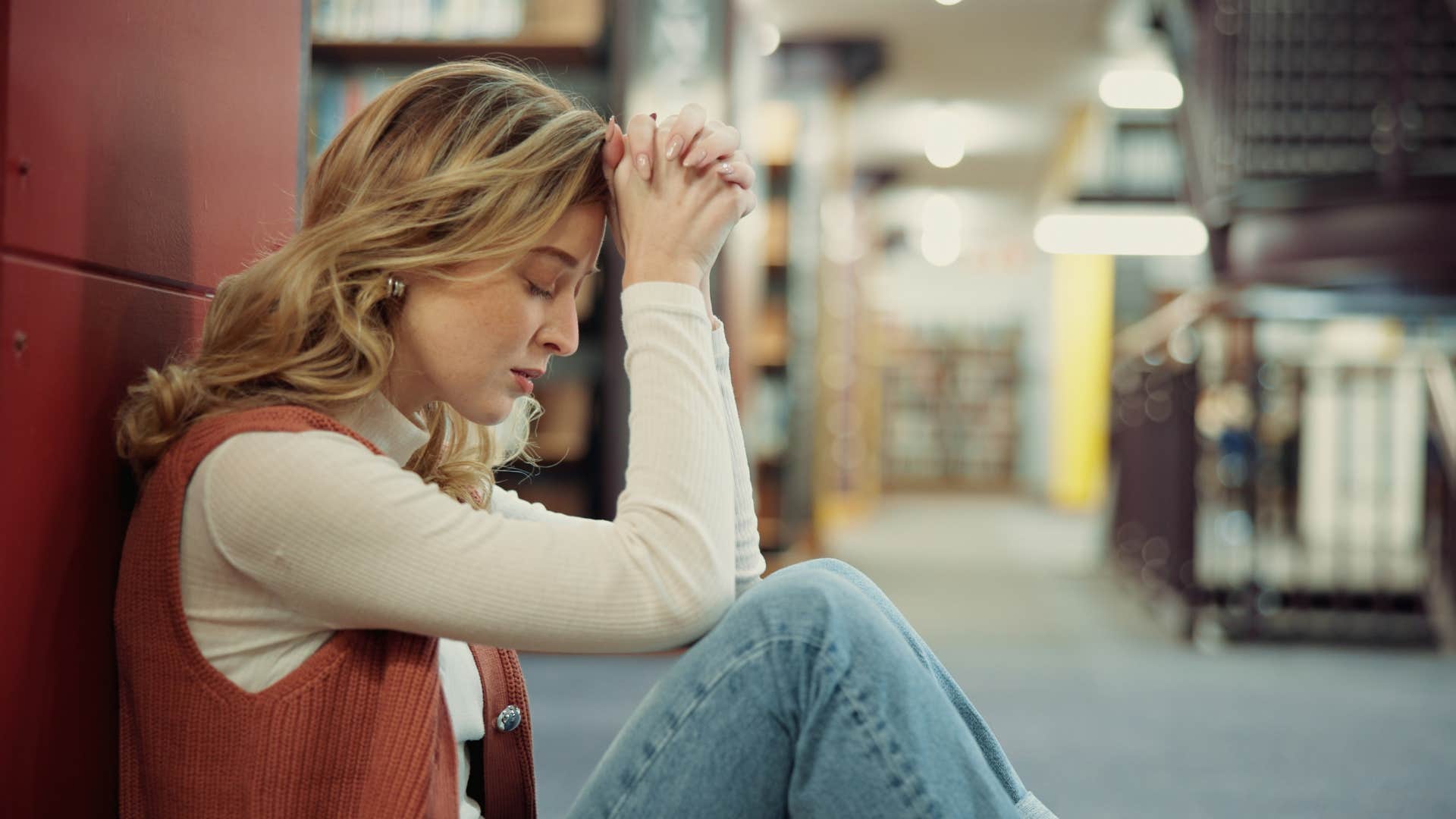 woman looking distraught after being rewarded for something that hurt others