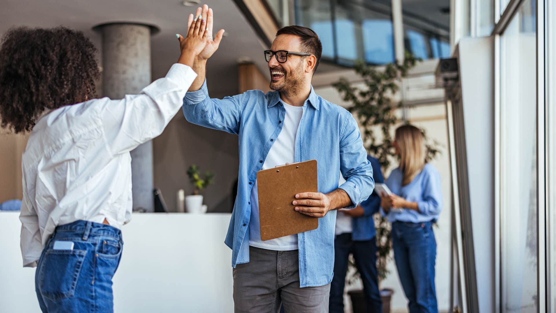 co-workers high fiving prioritizing winning over doing what's right