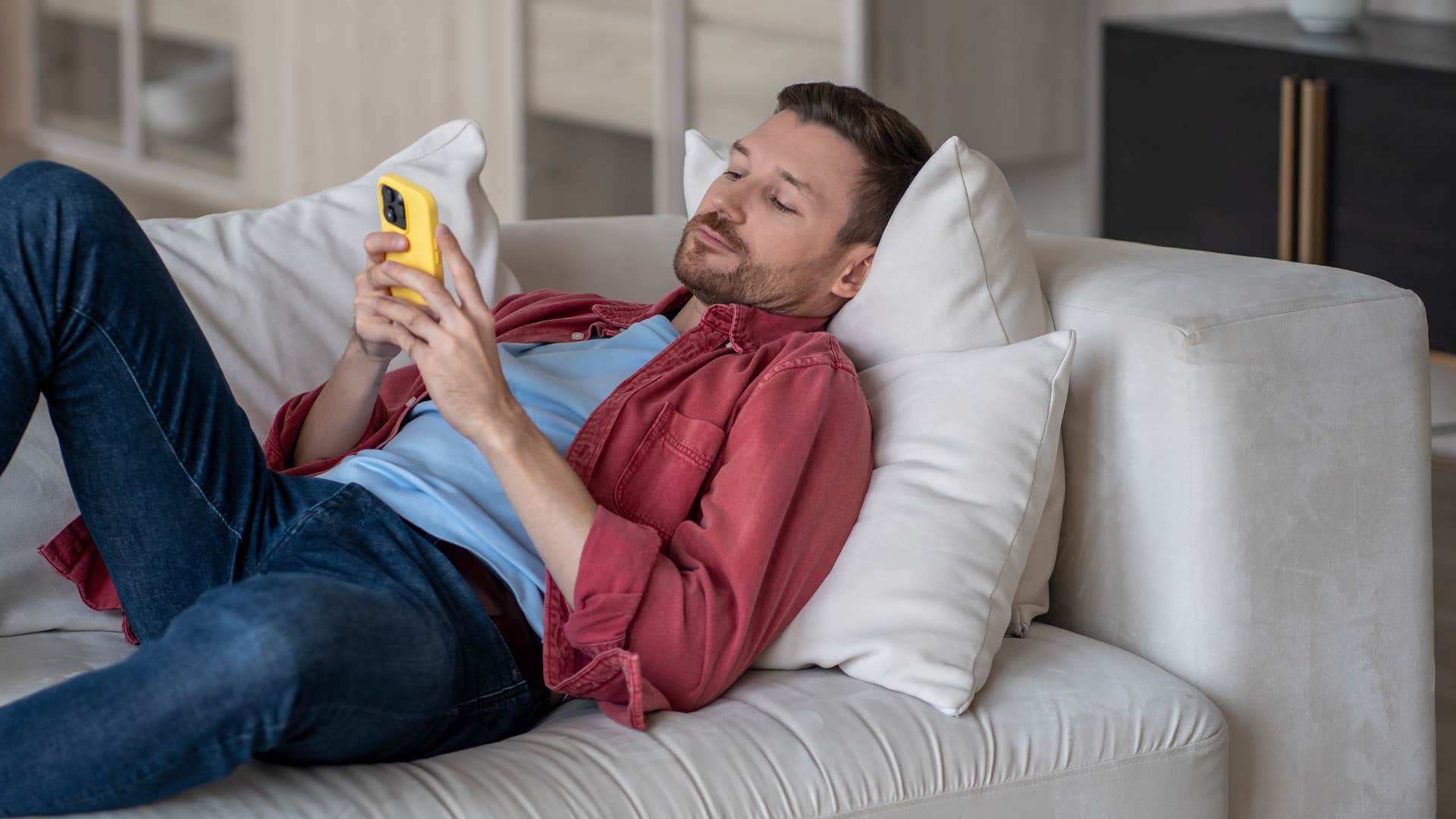 man being incompetent or lazy as he scrolls on phone