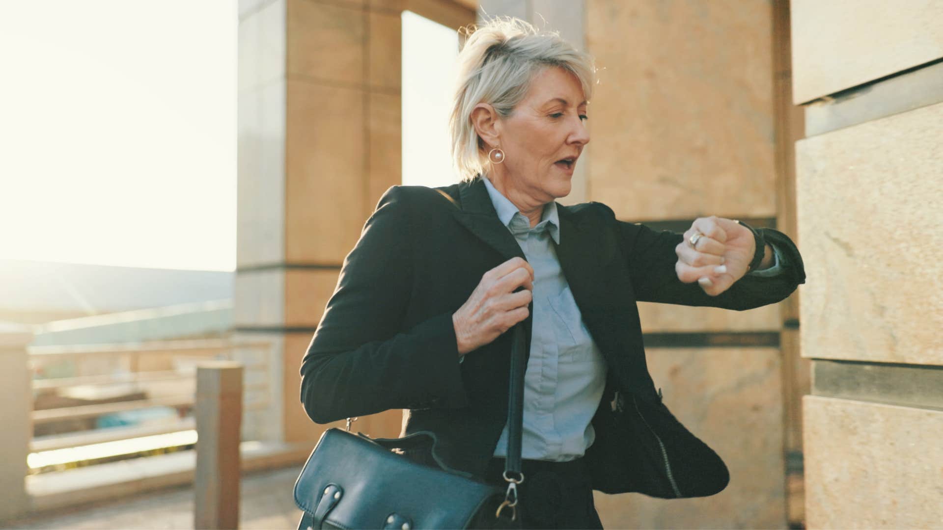 woman looking at watch as she has a lack of punctuality