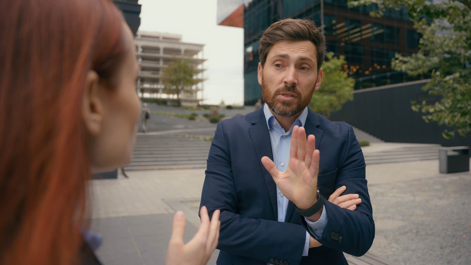 man in suit acting first and thinking second as he interrupts woman
