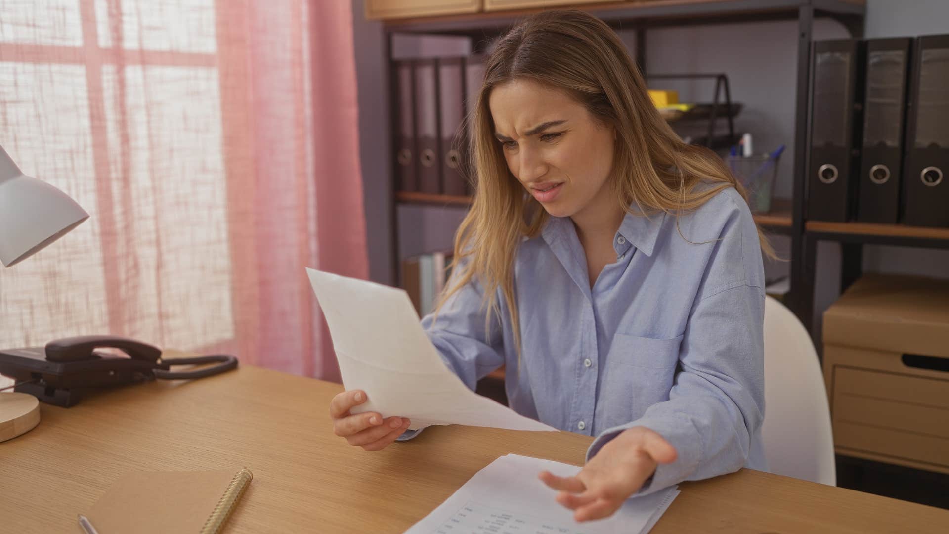 woman in blue shirt looking at rules that don't serve a purpose