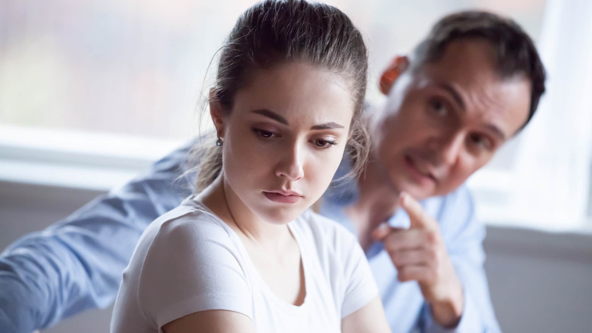 controlling man yelling at his upset scared partner