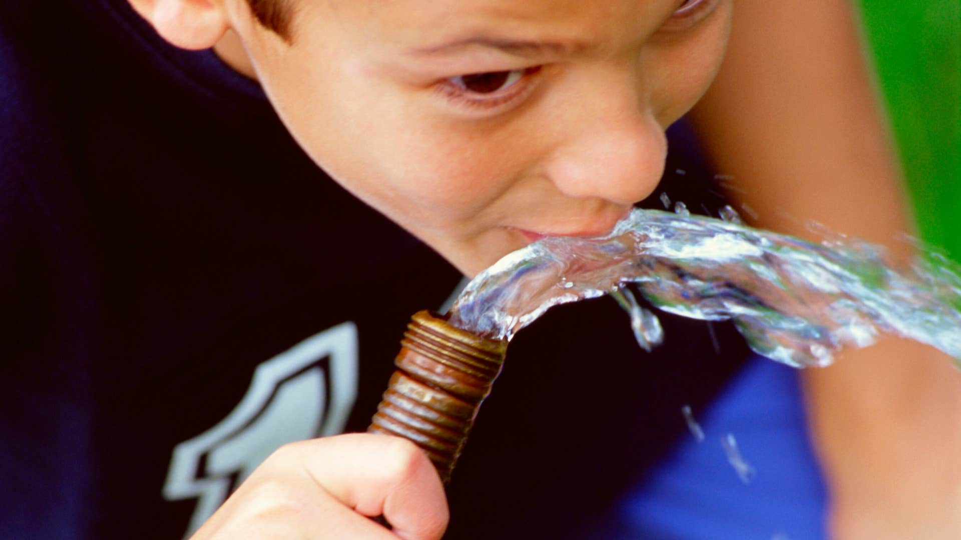 kid drinking from a hose like in the 1980s