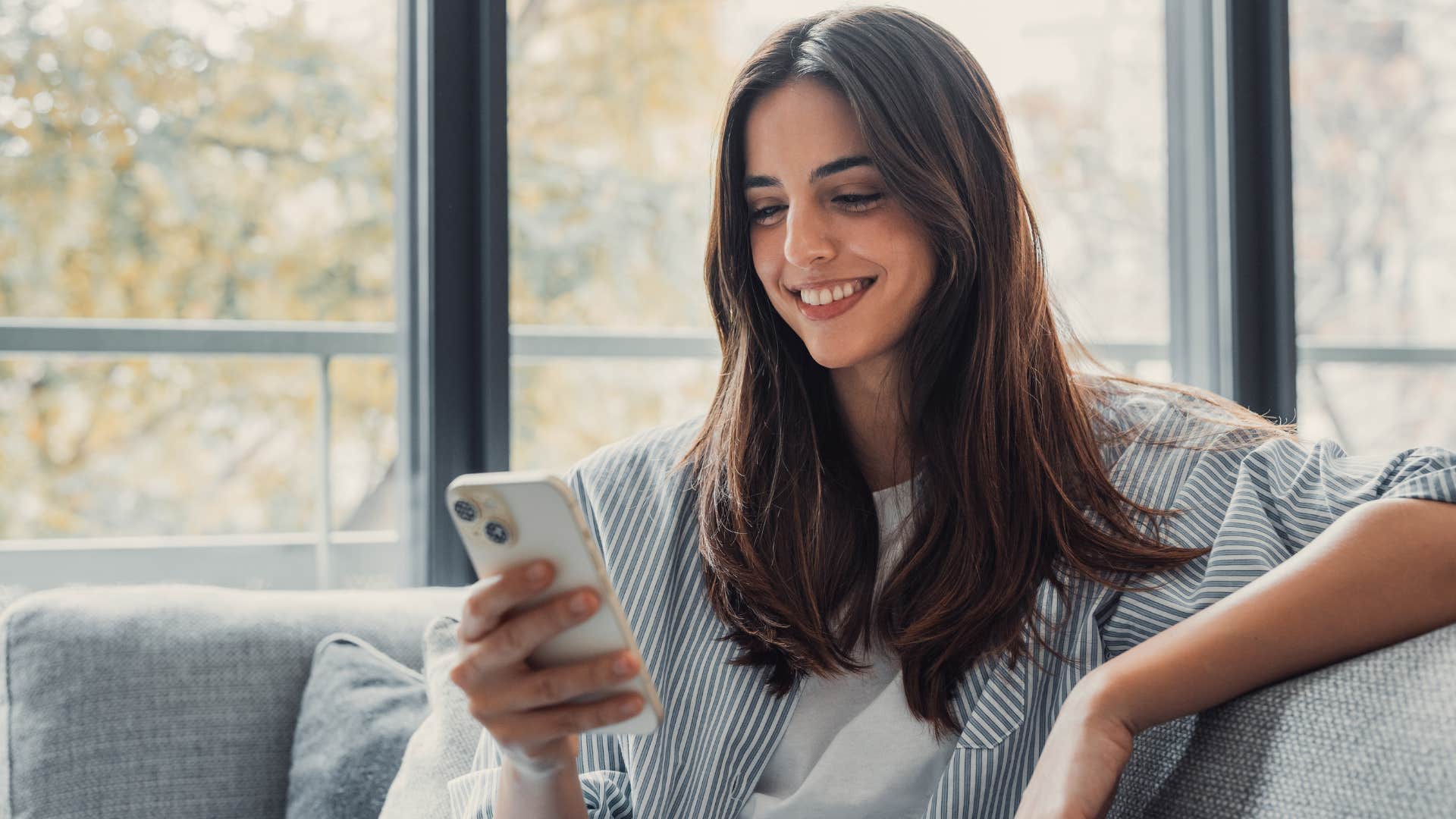 woman on couch muting notifications when at home