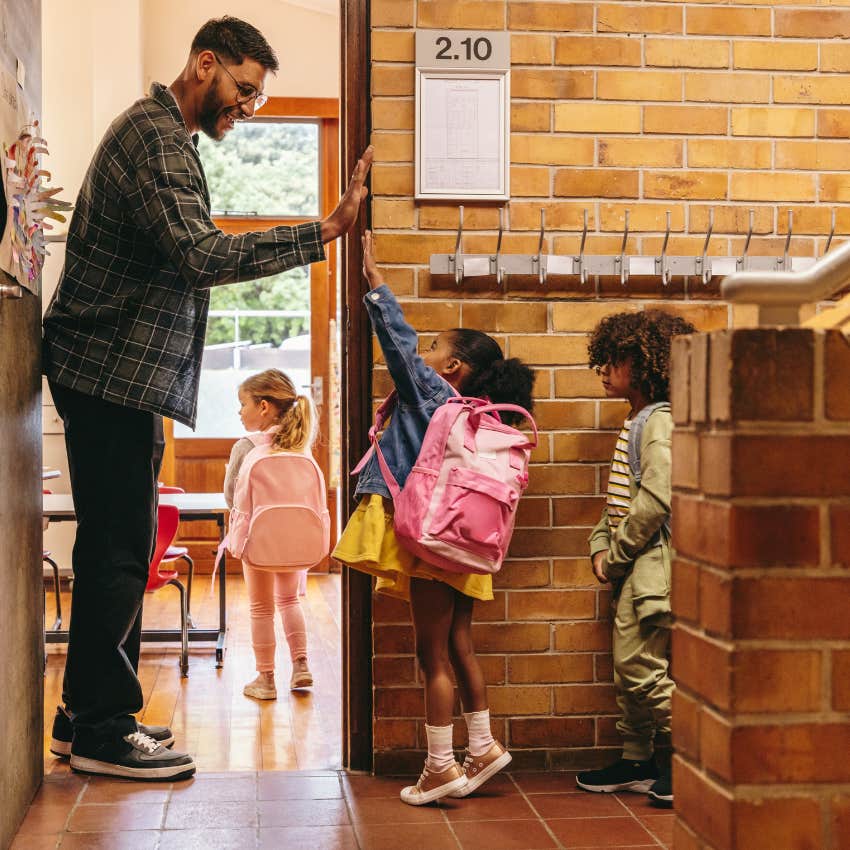 Teacher in Spain in sneakers without dress code and kids arriving to class without a bell