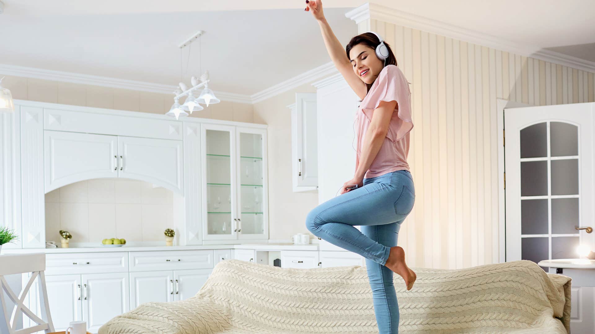 frugal woman having fun dancing at home