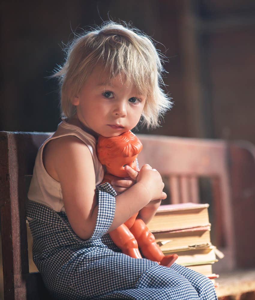 Calm toddler with toy doll showing think not to complicate raising boys