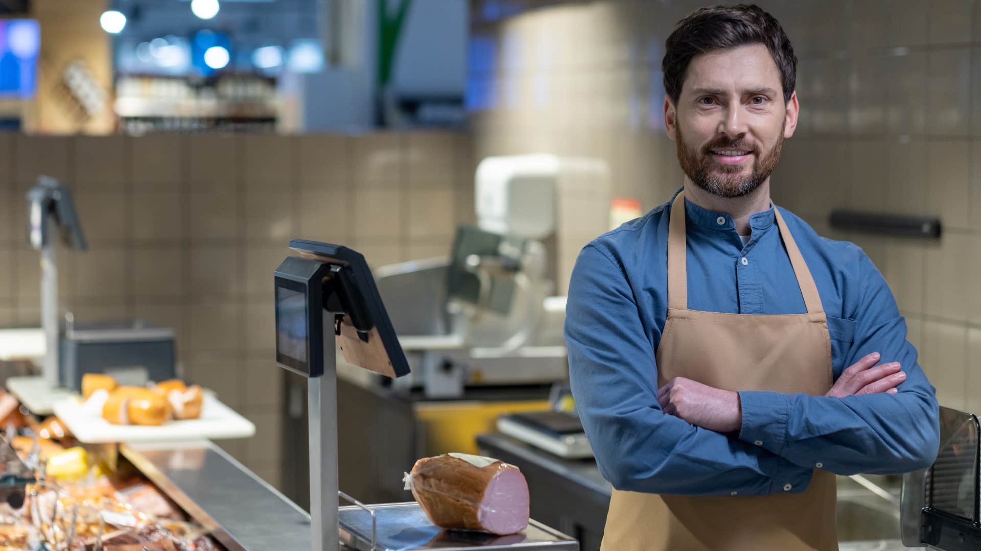 local butcher standing in his store