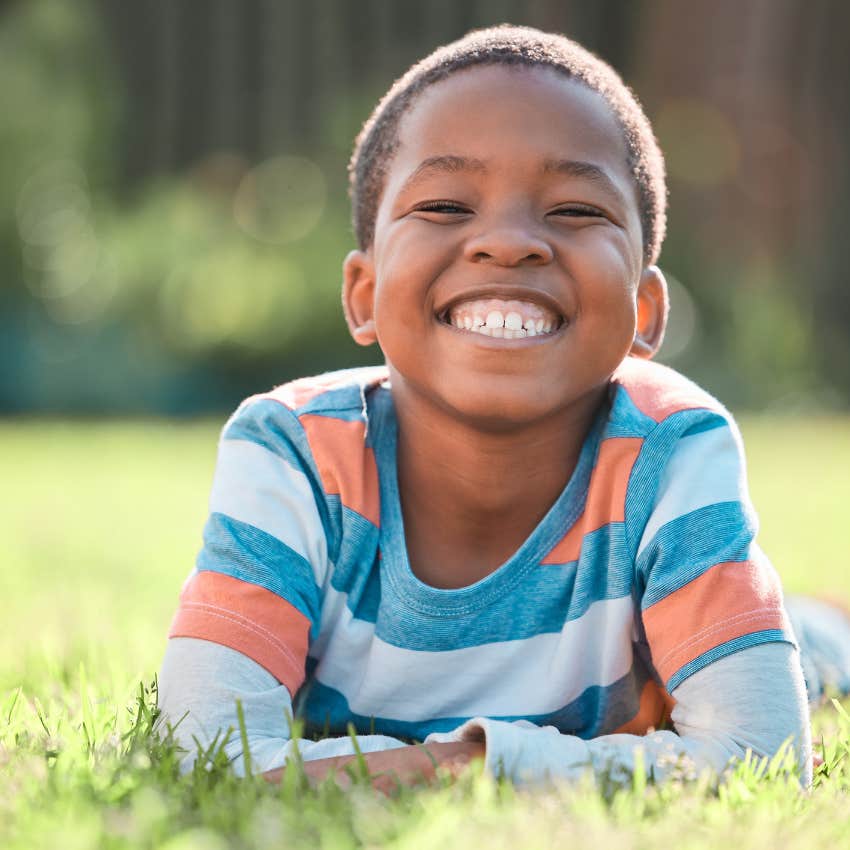 little boy enjoying free time outside in the grass