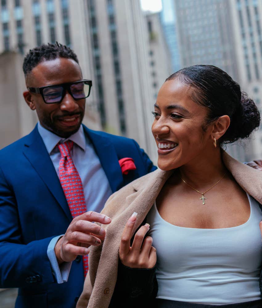 Attentive man helps woman with jacket showing closeness might be too good to be true
