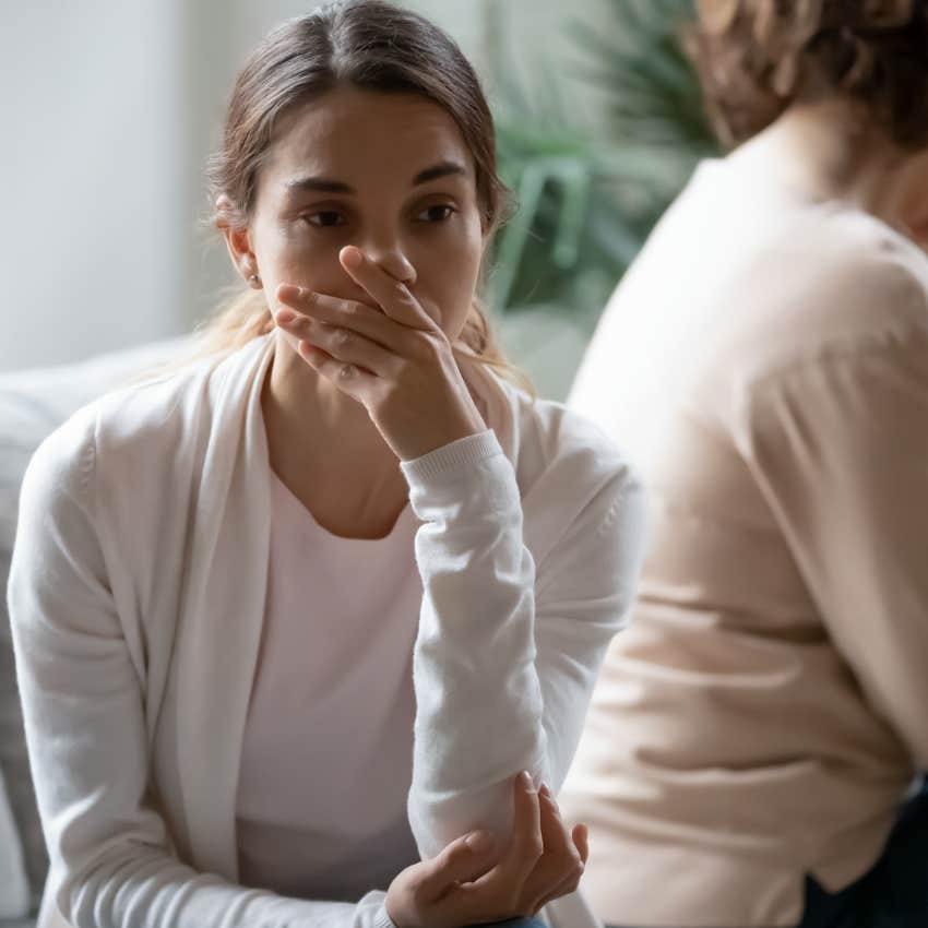 woman looking upset after talking about her life choices with her mom