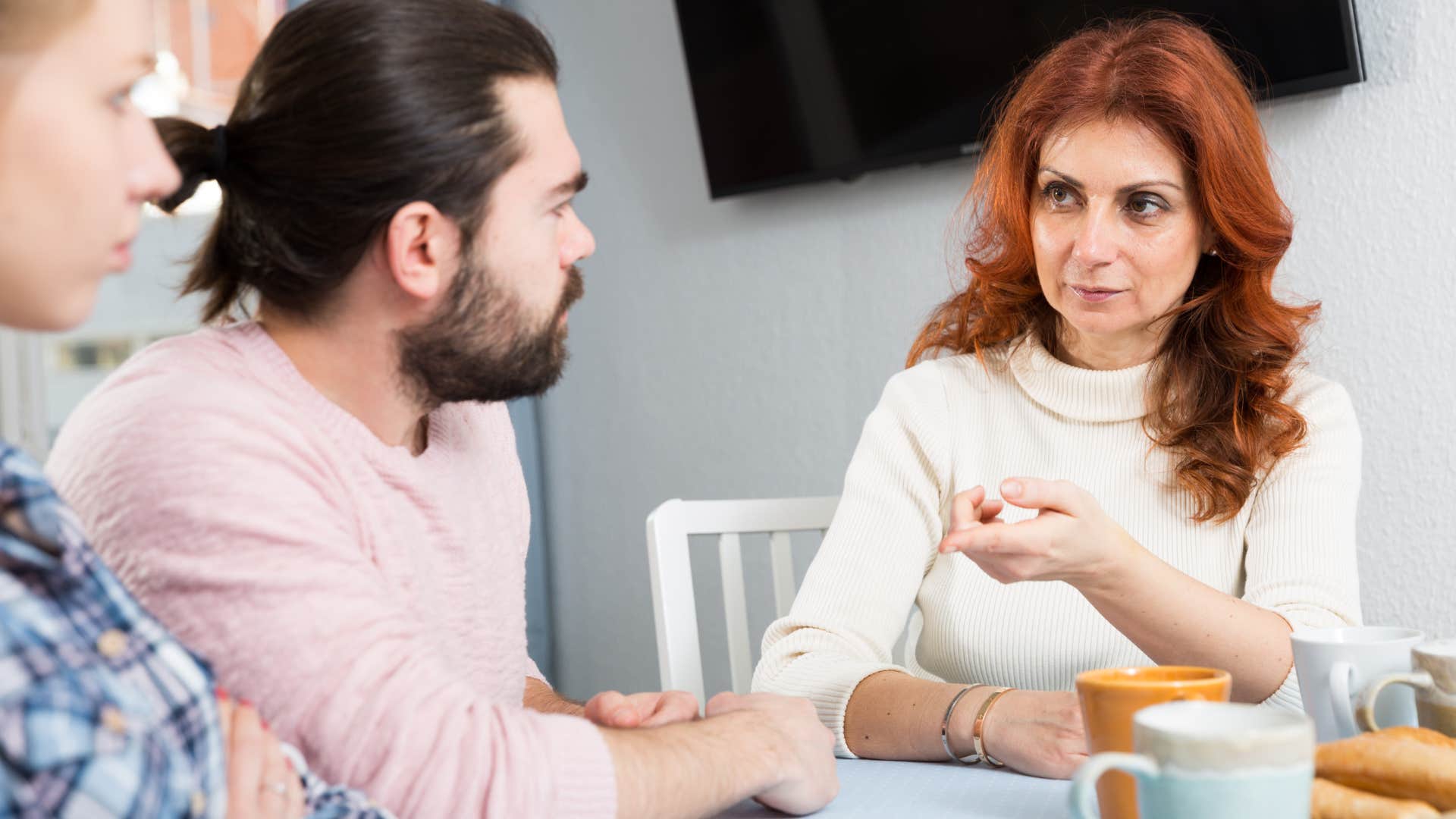 older woman asking couple if they want children